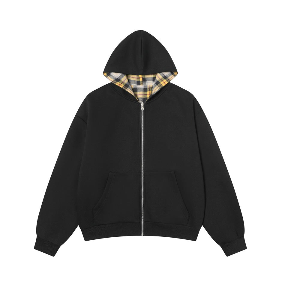 Black zip-up hooded jacket front view with front pocket, ribbed cuffs and hem, and plaid hood lining visible
