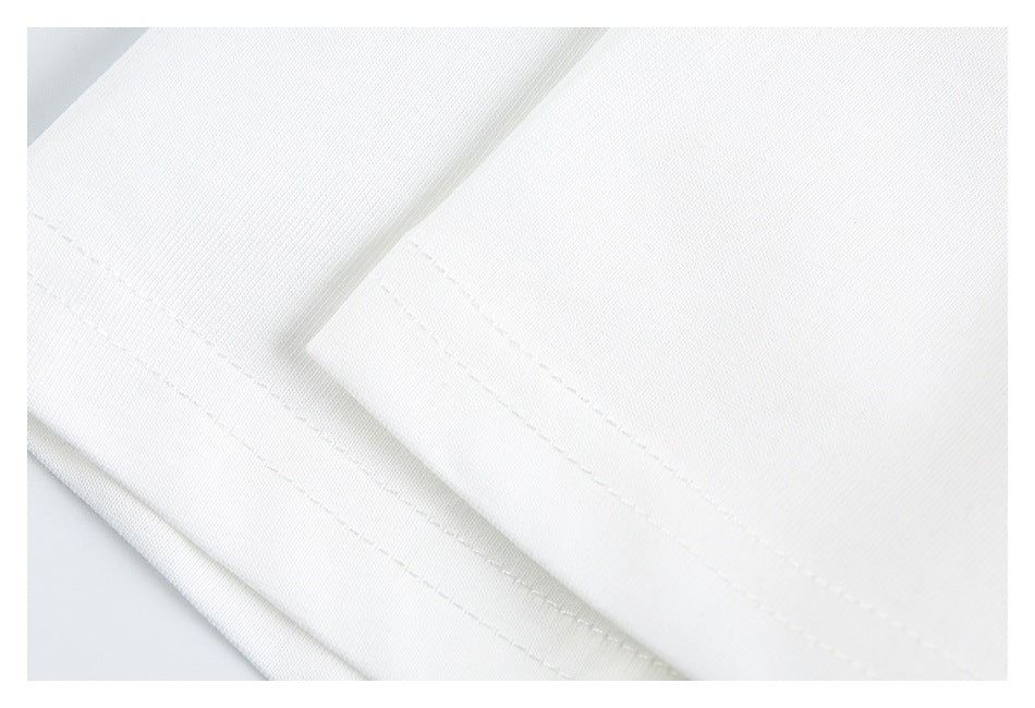 Close-up of parallel stitched hems on folded white garment fabric.