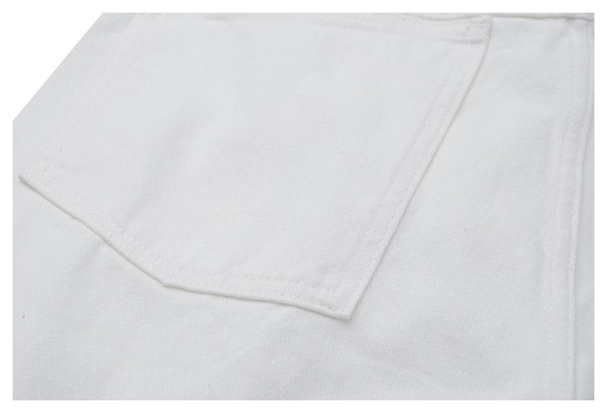 Close-up of a large angular patch pocket on white jeans.