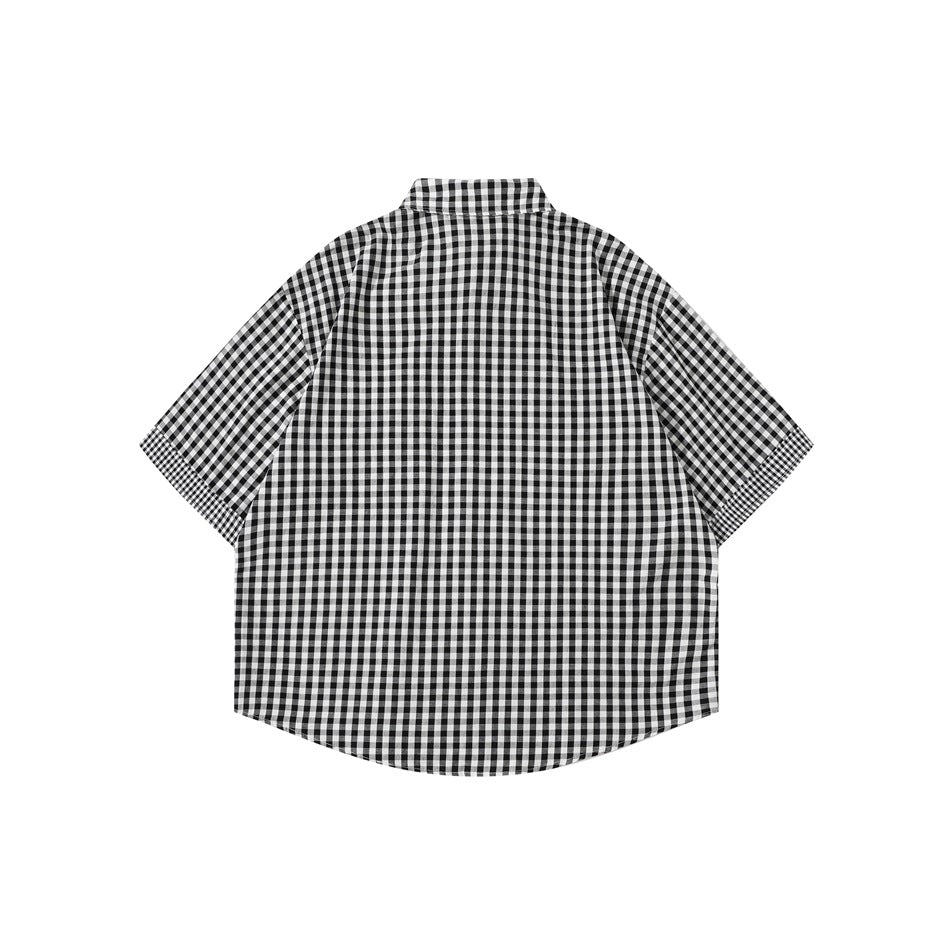 Back view of a short-sleeve black-and-white check button-up shirt on a plain white background.