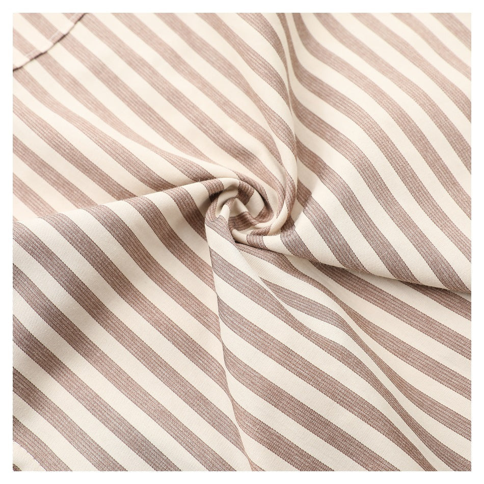 Close-up of cream fabric with narrow taupe stripes gathered into soft folds.