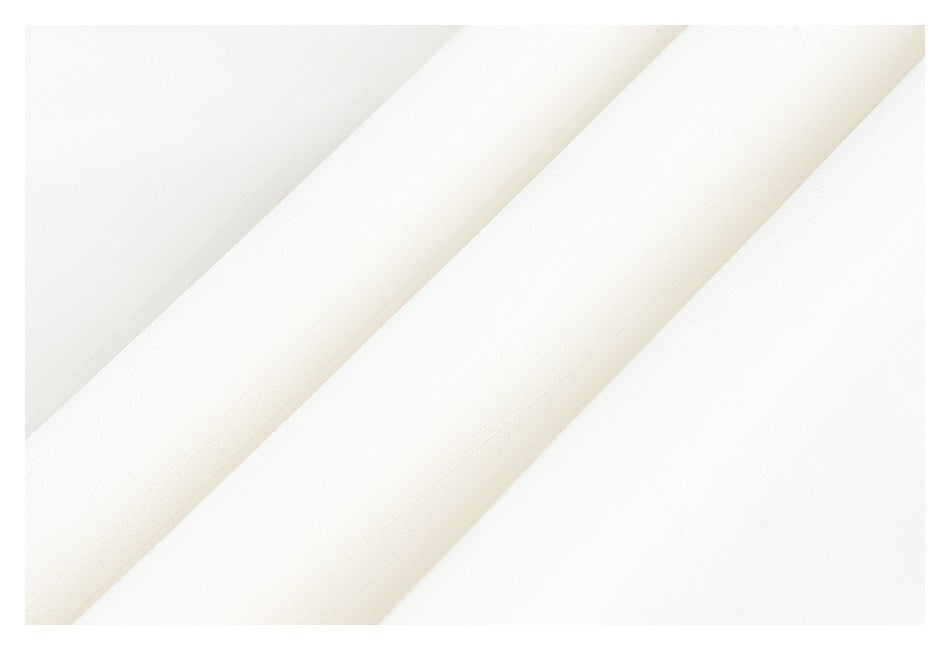 Close-up of smooth white garment fabric arranged in diagonal folds.