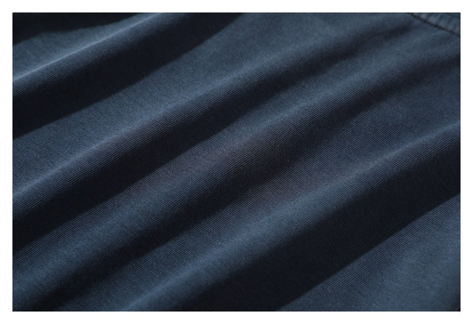 Close-up showing the fine knit texture and folds of dark navy fabric.