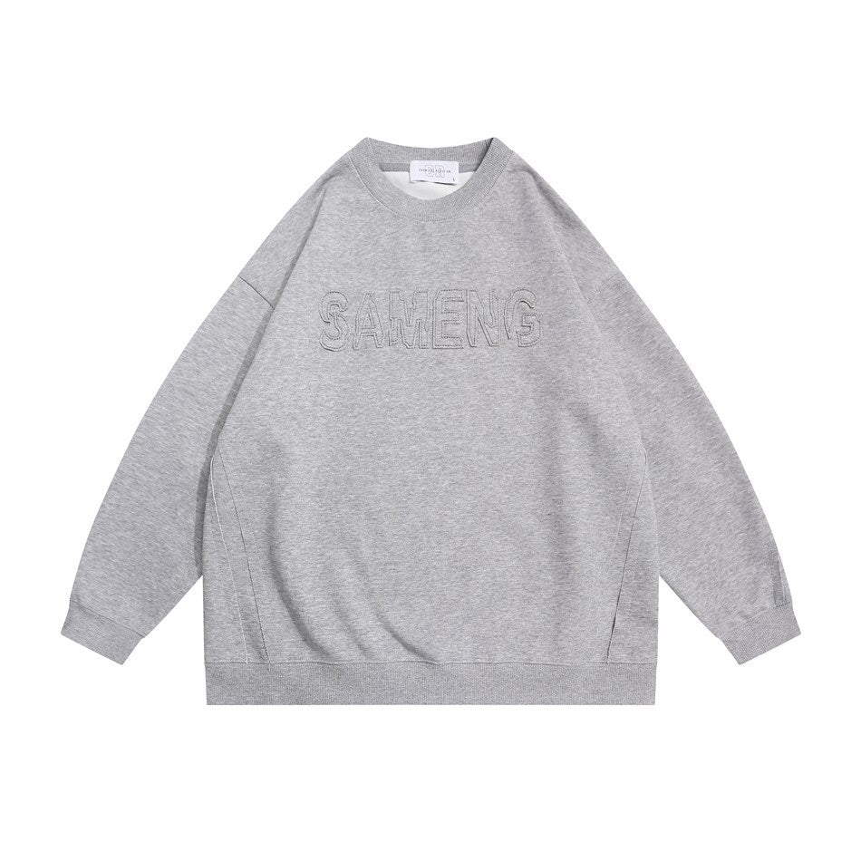 Light gray crew-neck sweatshirt flat lay with raised stitched outline lettering on the chest and ribbed trim