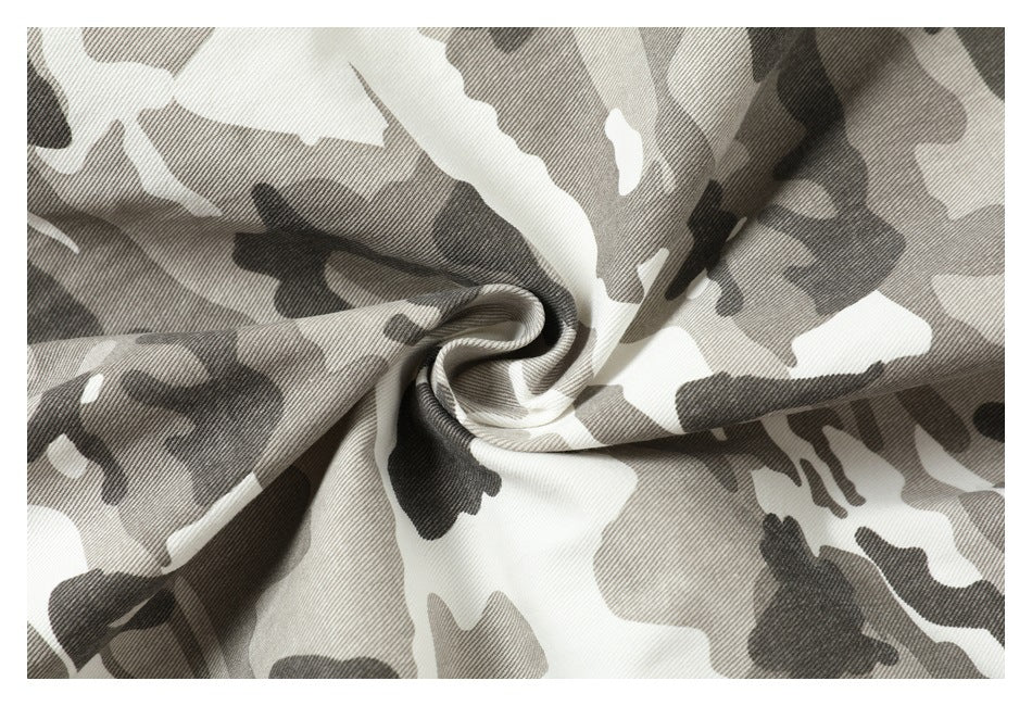Close-up of gray, white, and black camouflage-patterned fabric gathered into a twist.