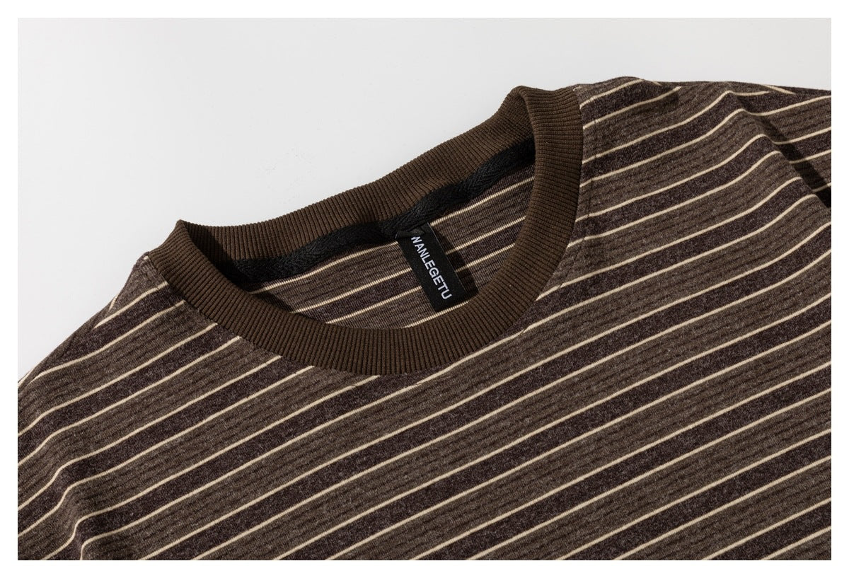 Close-up of a dark brown striped shirt's ribbed crew neckline and inner neck label.