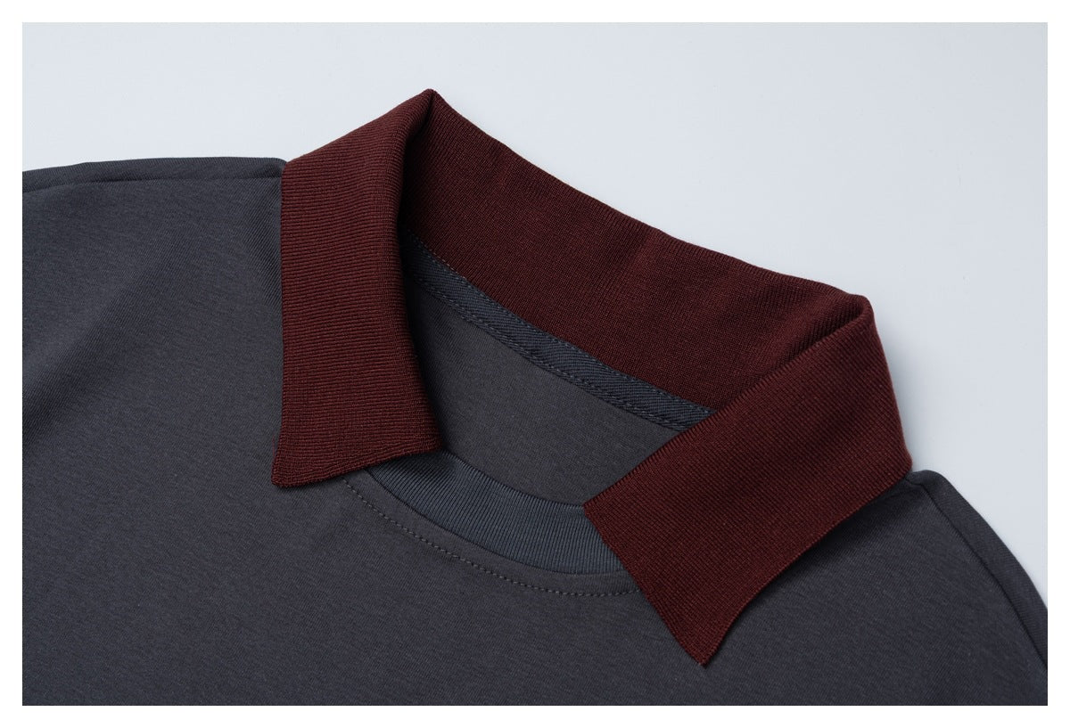 Close-up of a charcoal shirt's burgundy ribbed collar and neckline stitching.