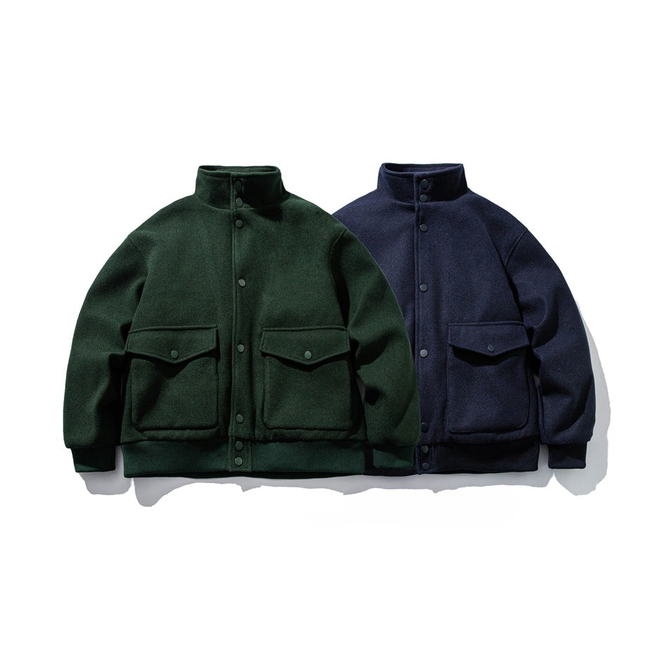 Front view of two snap-front jackets with stand collars and flap pockets, one forest green and one navy.