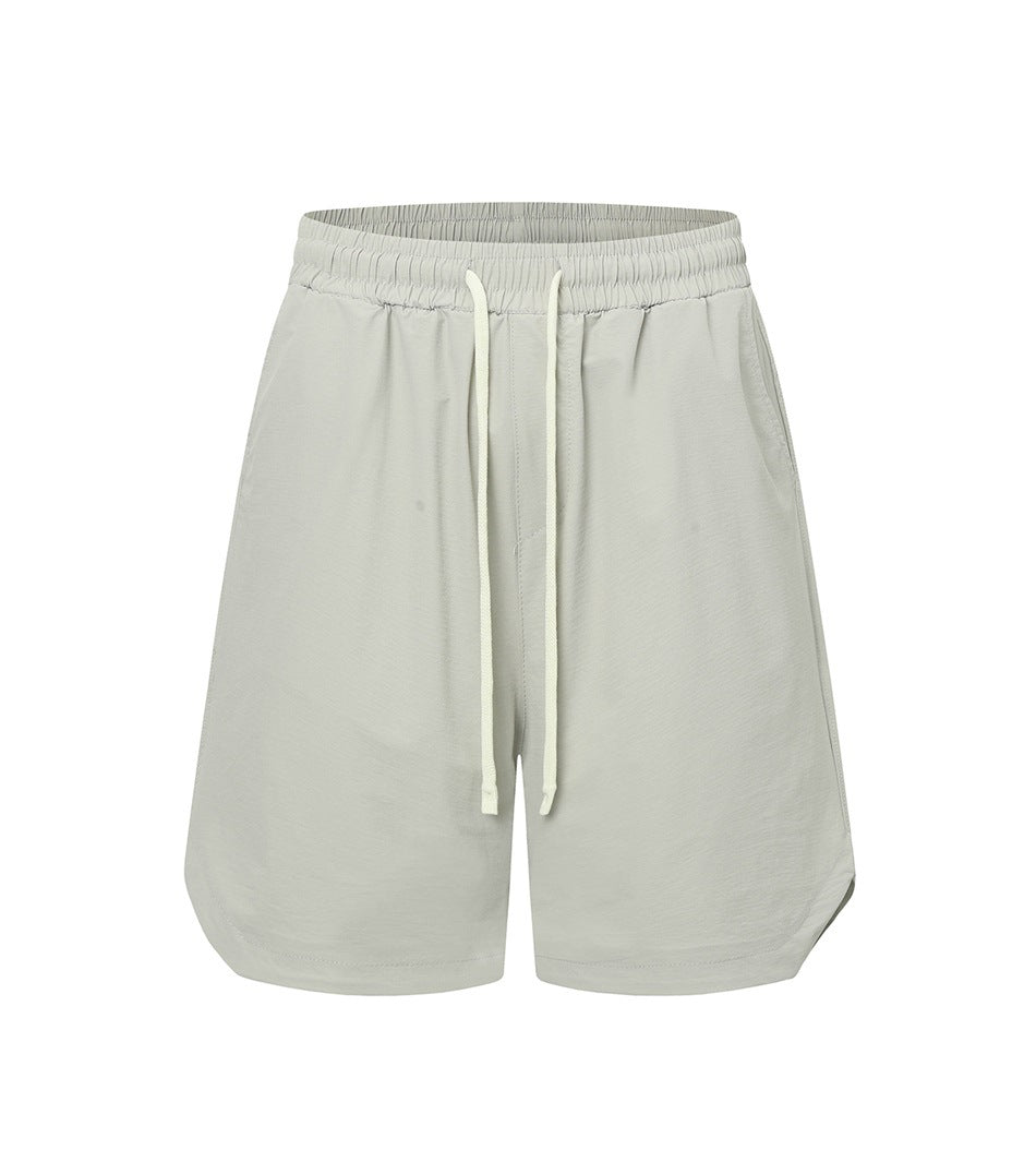 Light gray drawstring shorts with elastic waistband and curved side hems, front view on white background