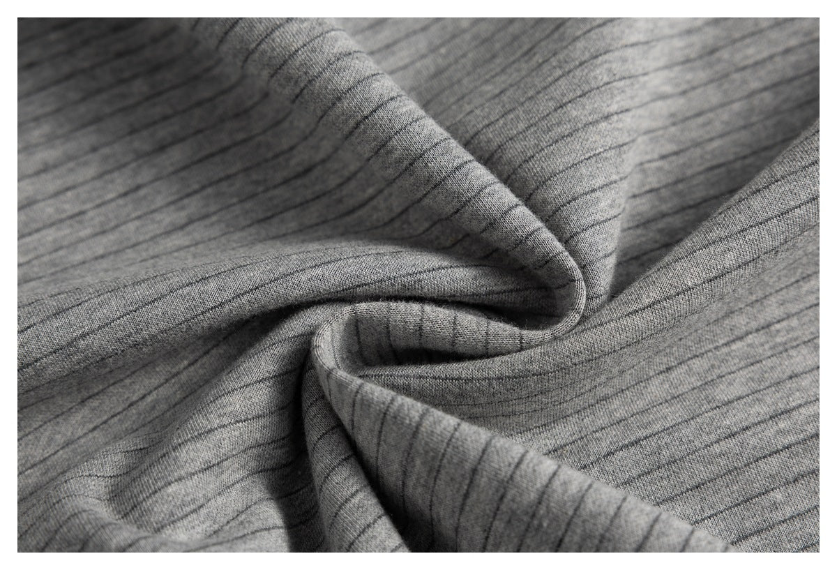 Close-up of gray pinstriped fabric gathered into a swirl to show its texture and drape.