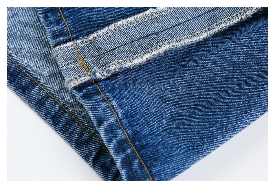Close-up of a blue denim leg seam and finished inner stitching.