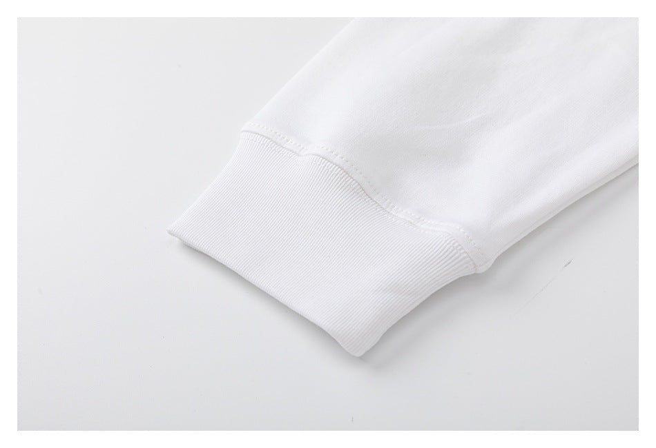 Close-up of a white garment sleeve ending in a wide ribbed cuff with visible stitching.