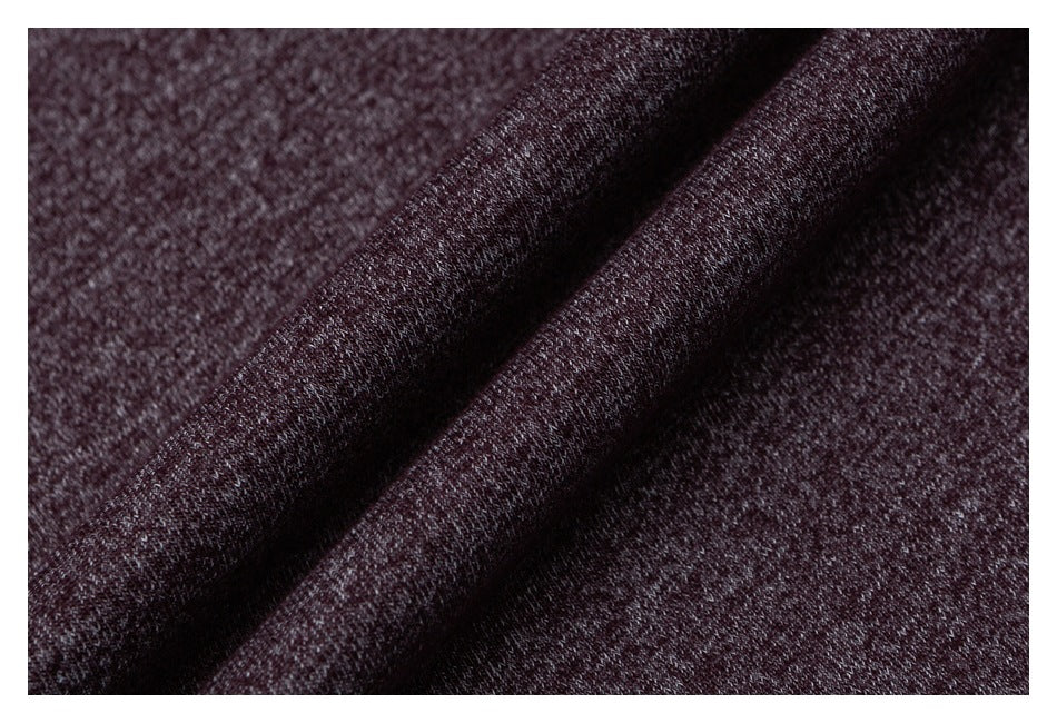 Macro view of burgundy heathered knit fabric draped into soft folds.