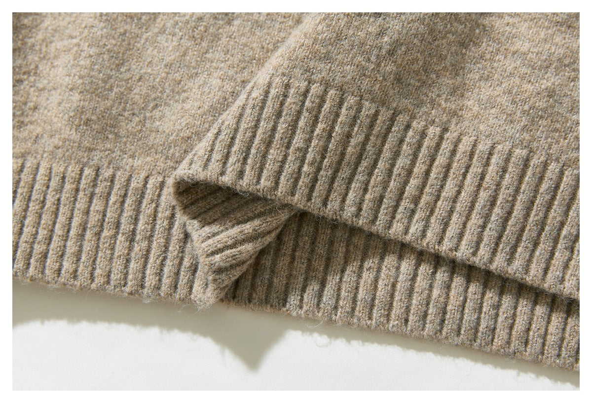 Close-up of the beige sweater’s ribbed hem and sleeve cuff.