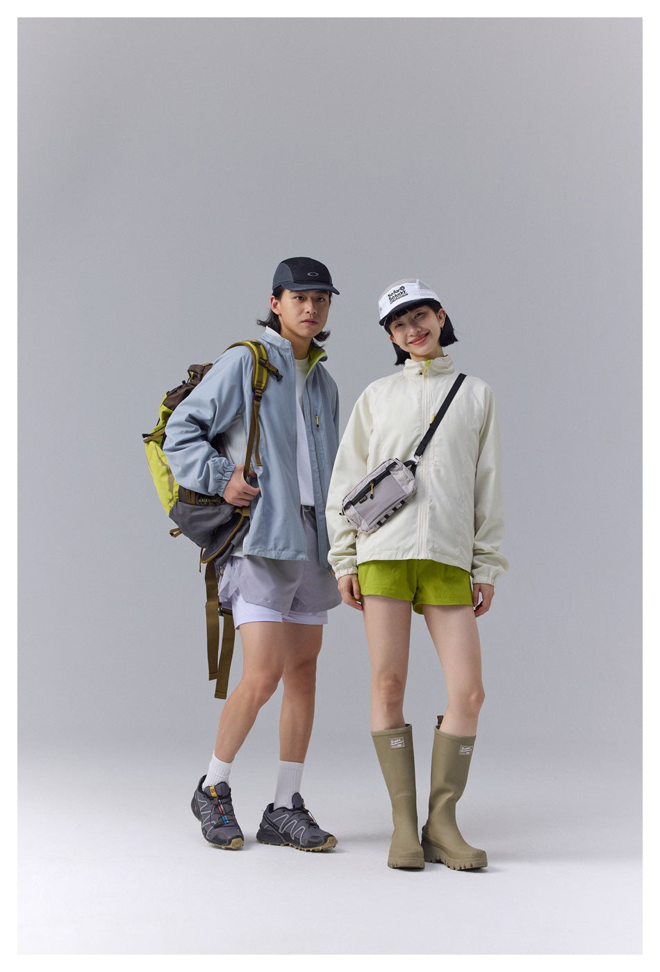 Two models pose in outdoor jackets: an ivory jacket with lime shorts and a blue-gray jacket with pale shorts.