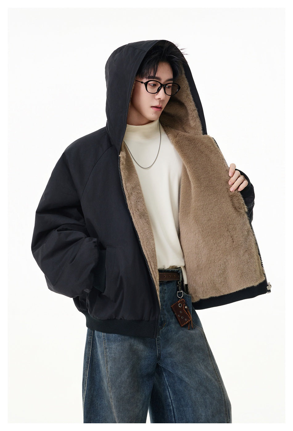 Model wearing an open black hooded jacket with taupe plush lining, dark ribbed cuffs and hem.