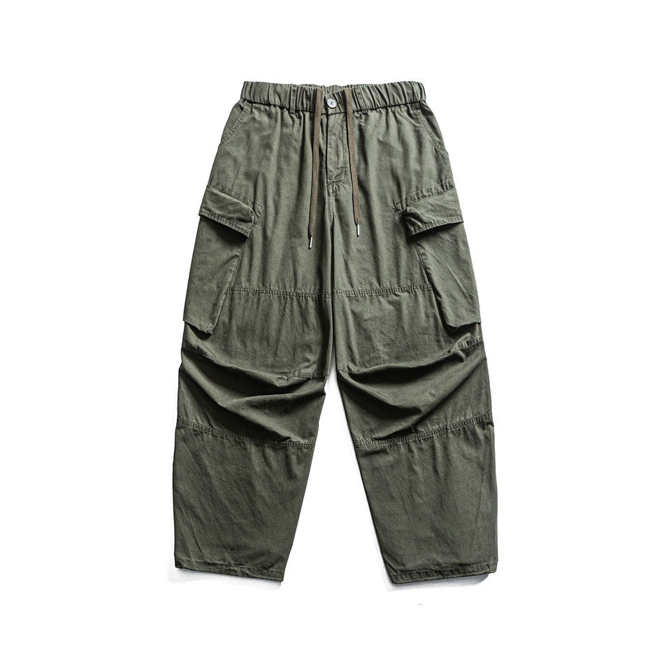 Olive green wide-leg cargo pants with flap pockets and drawstring elastic waist, flat lay