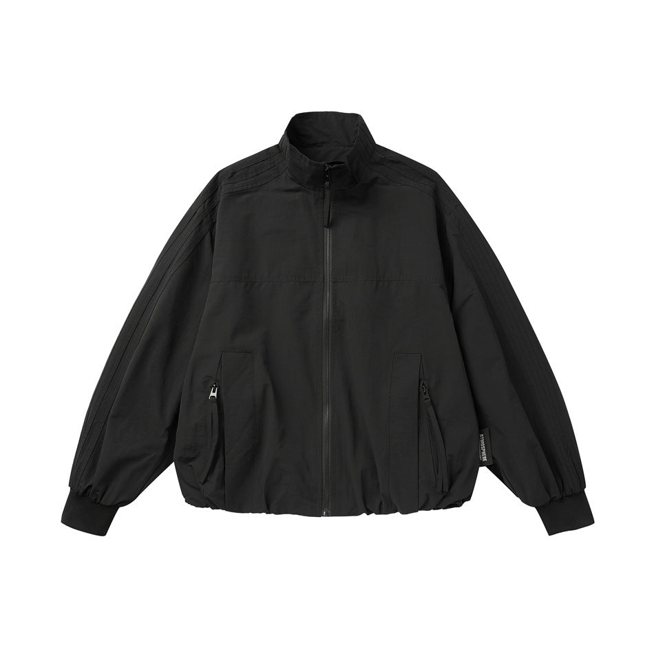 Black stand-collar zip jacket with zippered front pockets, ribbed cuffs and gathered hem, flat front view