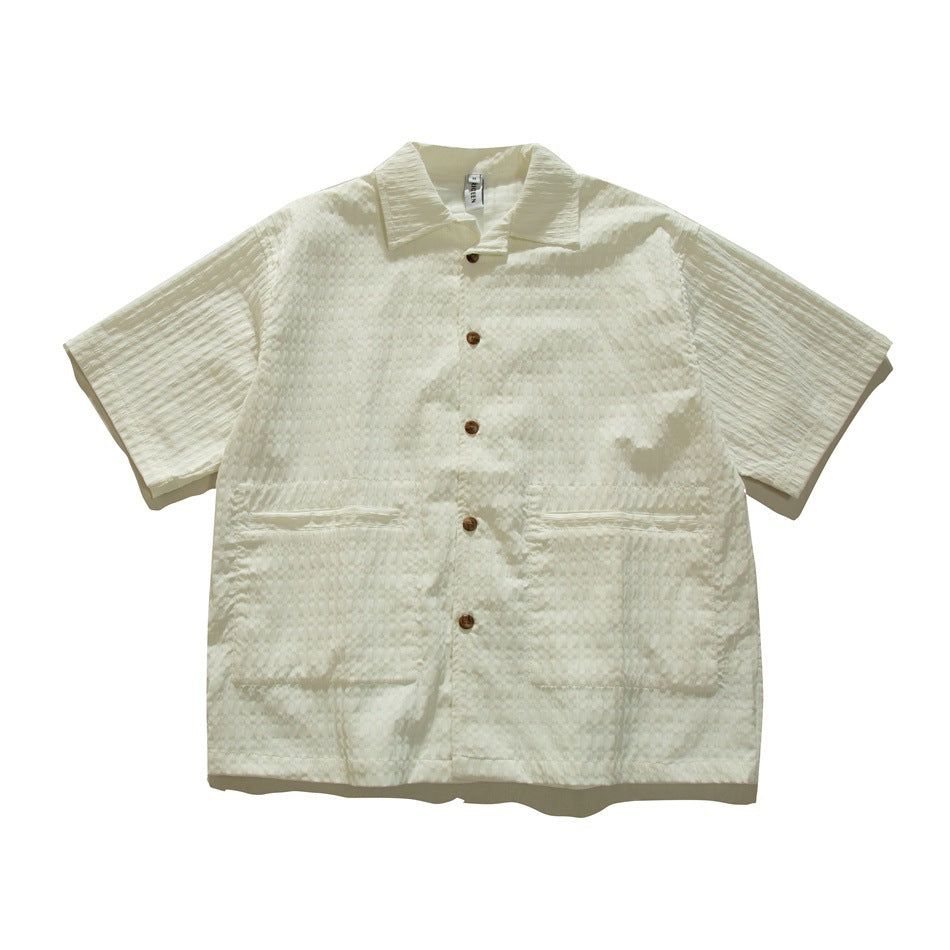 Cream-white short-sleeve textured button-up shirt with collar and two large front patch pockets, flat lay