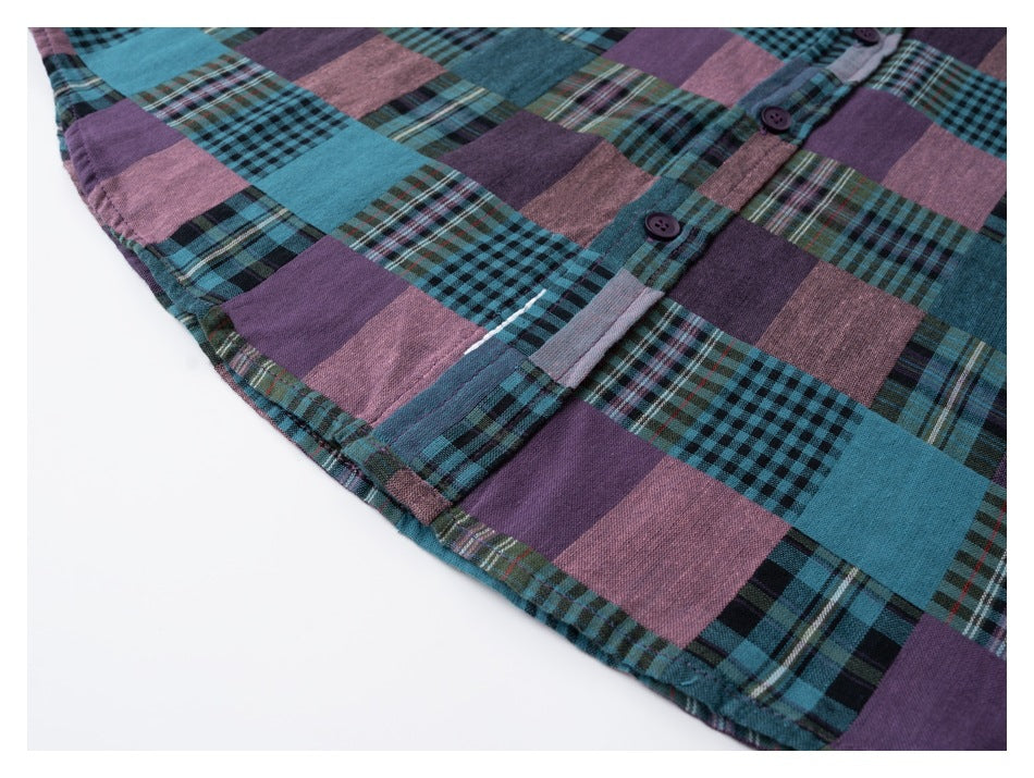 Close-up of the curved hem and button placket on a teal, purple, and pink patchwork plaid shirt.