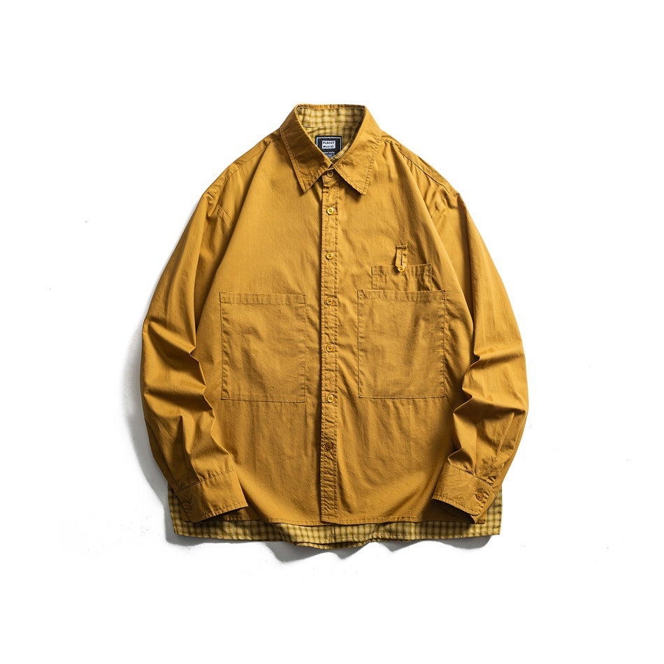 Front view of a mustard button-up shirt laid flat, with two large pockets and yellow plaid lining at the hem.