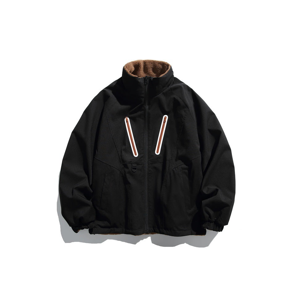 Front view of a black jacket with a brown-lined stand collar, two chest zippers, zip front, and elastic cuffs.