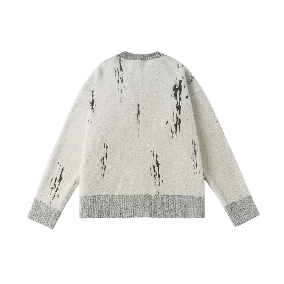 Back of an ivory fuzzy knit cardigan with dark abstract streaks, a gray ribbed neckline, cuffs, and hem.