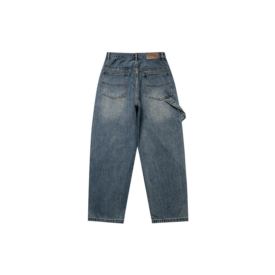 Back view of washed blue wide-leg jeans with two patch pockets and a brown waistband patch