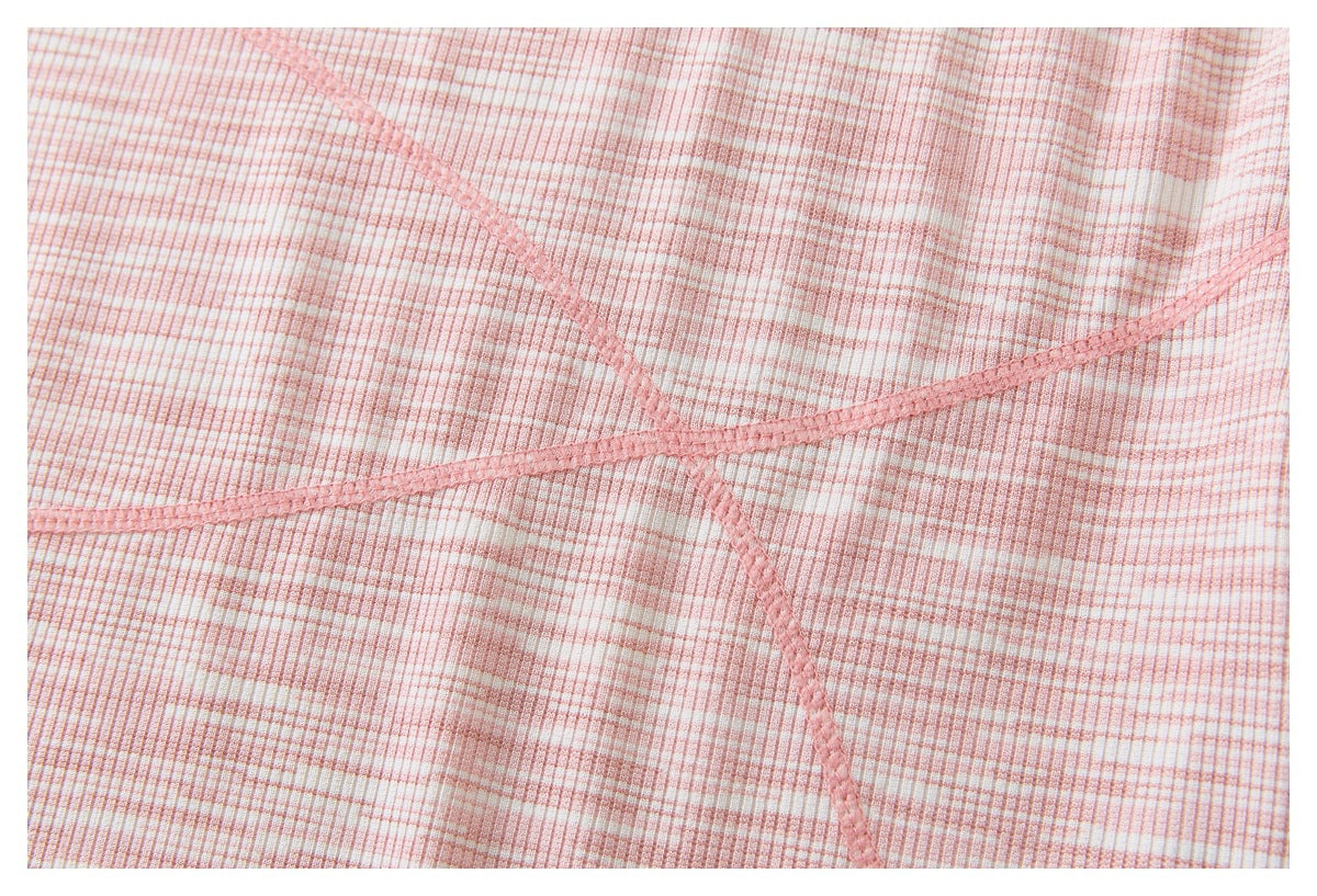 Close-up of pink-and-white ribbed striped fabric with intersecting pink overlock seams.