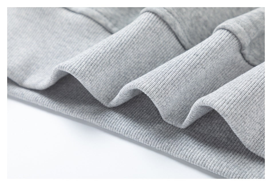 Close-up of ribbed heather gray garment hems and cuffs.