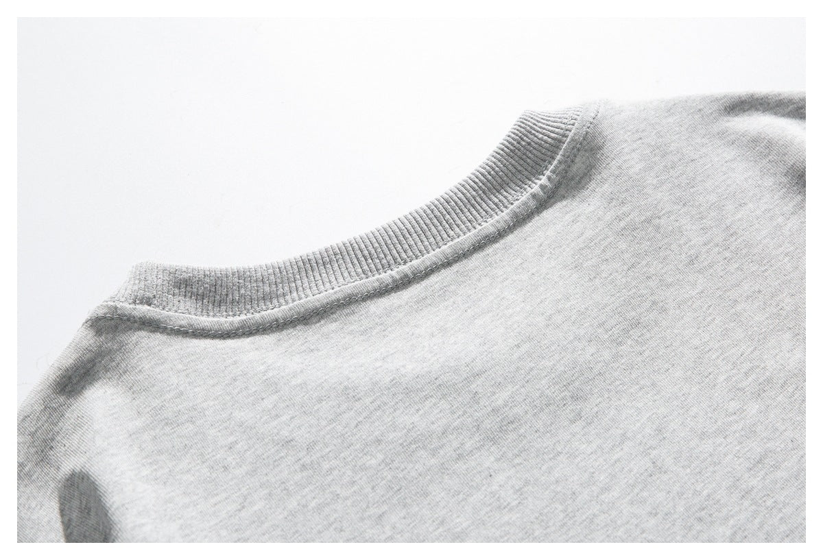 Close-up of the back neckline of a light gray shirt with a ribbed collar.