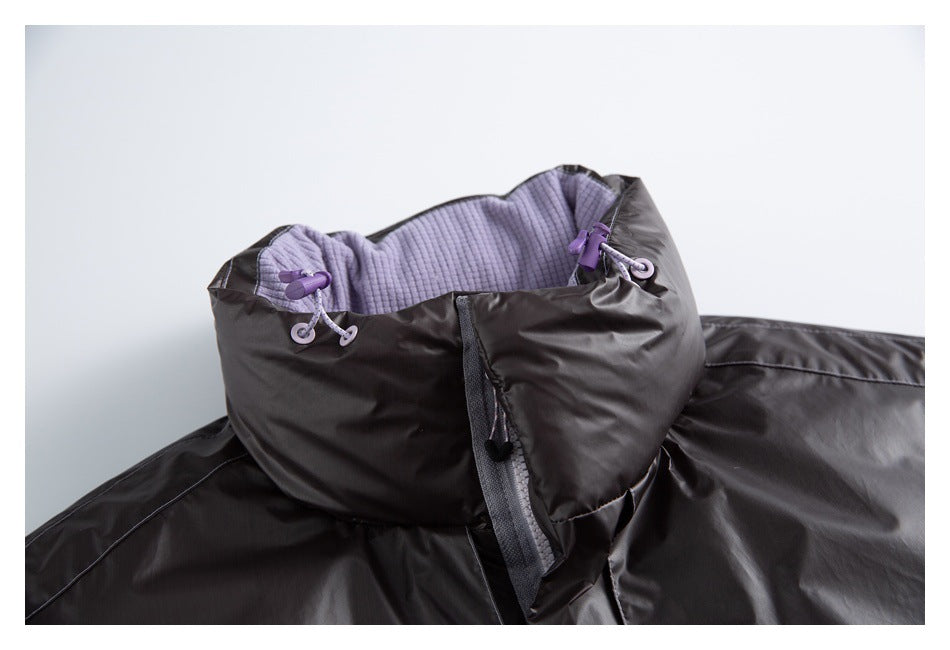 Close-up of the dark vest's high collar, purple lining, drawcords, and front closure.