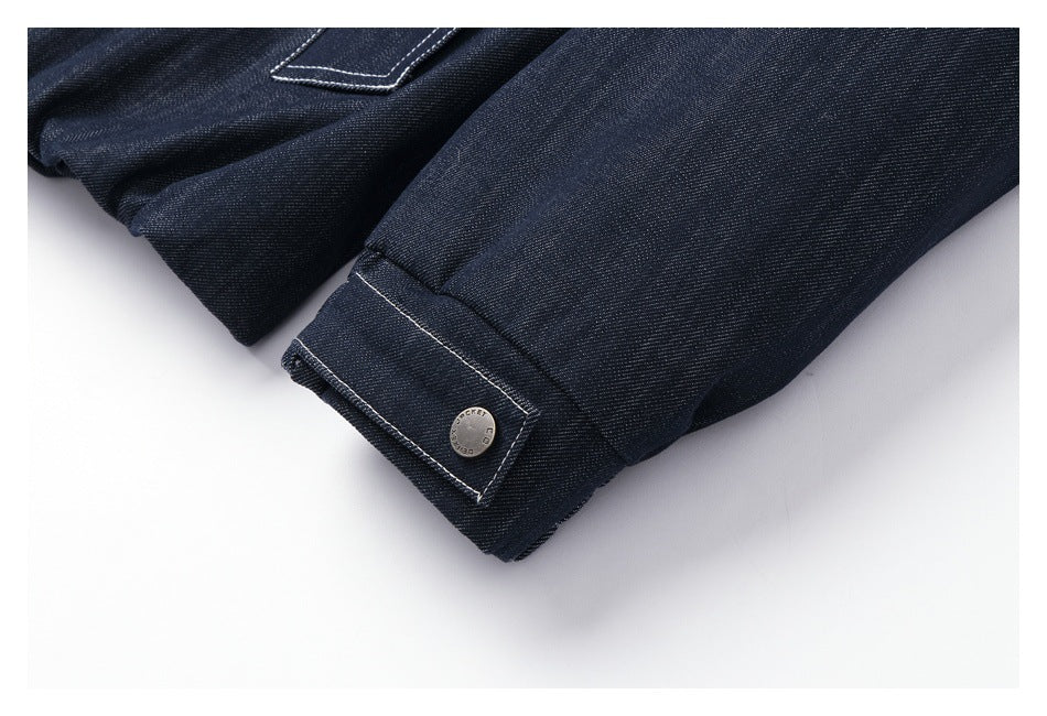 Close-up of a dark navy garment cuff with contrast stitching and a round metal button.