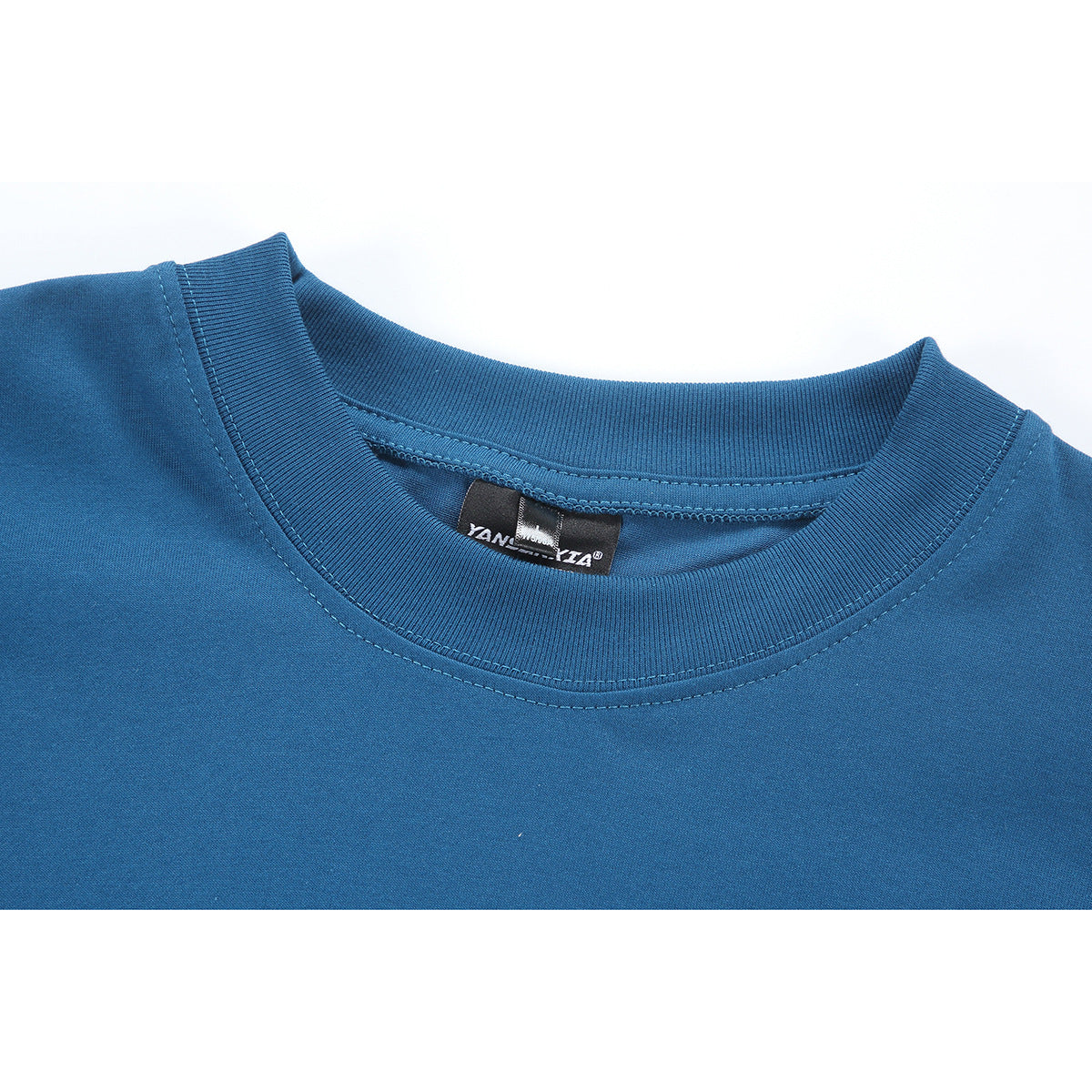 Close-up of a blue long-sleeve shirt’s ribbed crew neck and inner label.