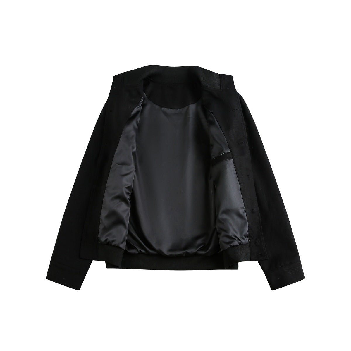 Open black jacket laid flat, showing its dark satin-like lining, inner pocket, cuffs, and front fastening edge.