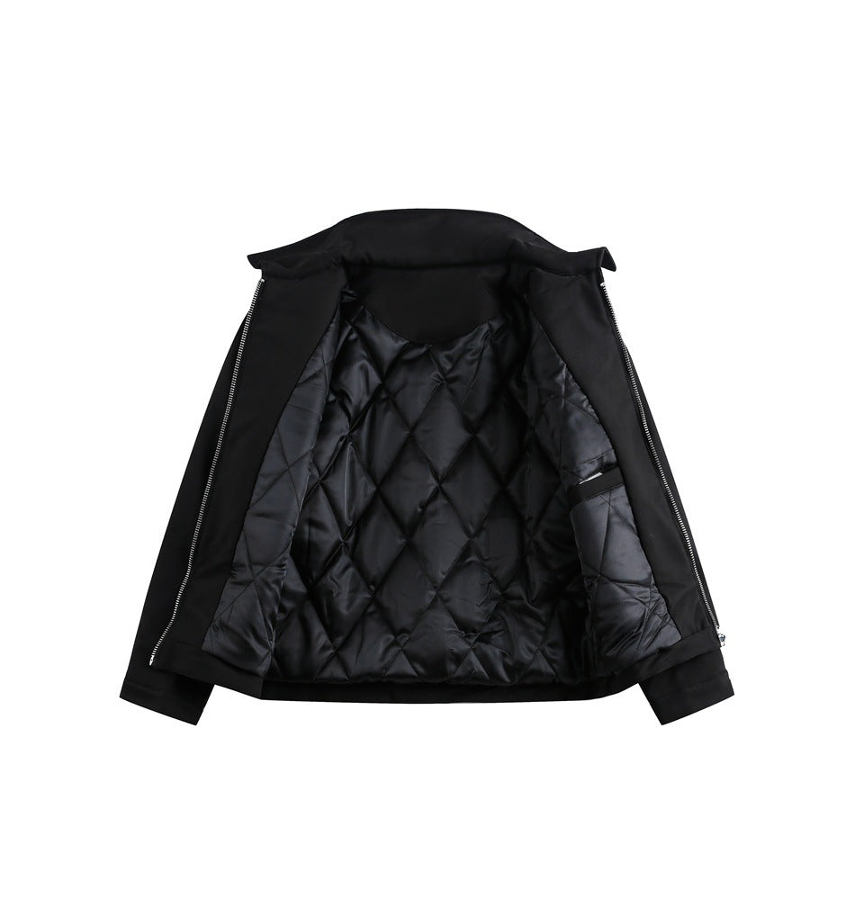 Black jacket laid open to show its shiny diamond-quilted lining and front zipper edges.