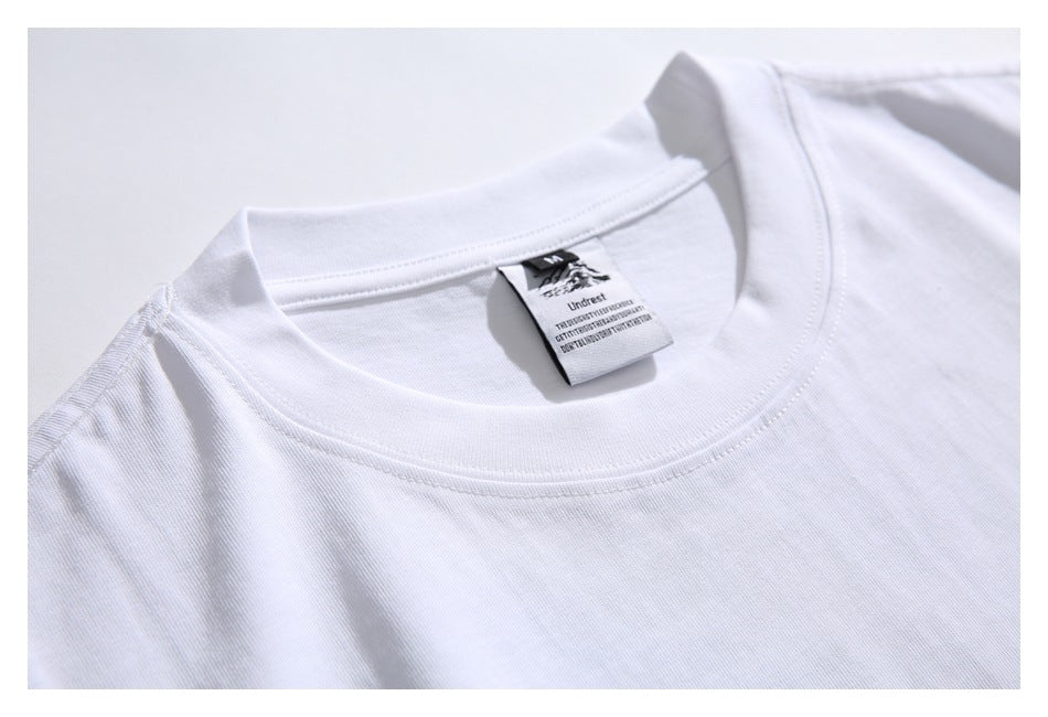 Close-up of the white shirt's crew-neck stitching and attached neck label.