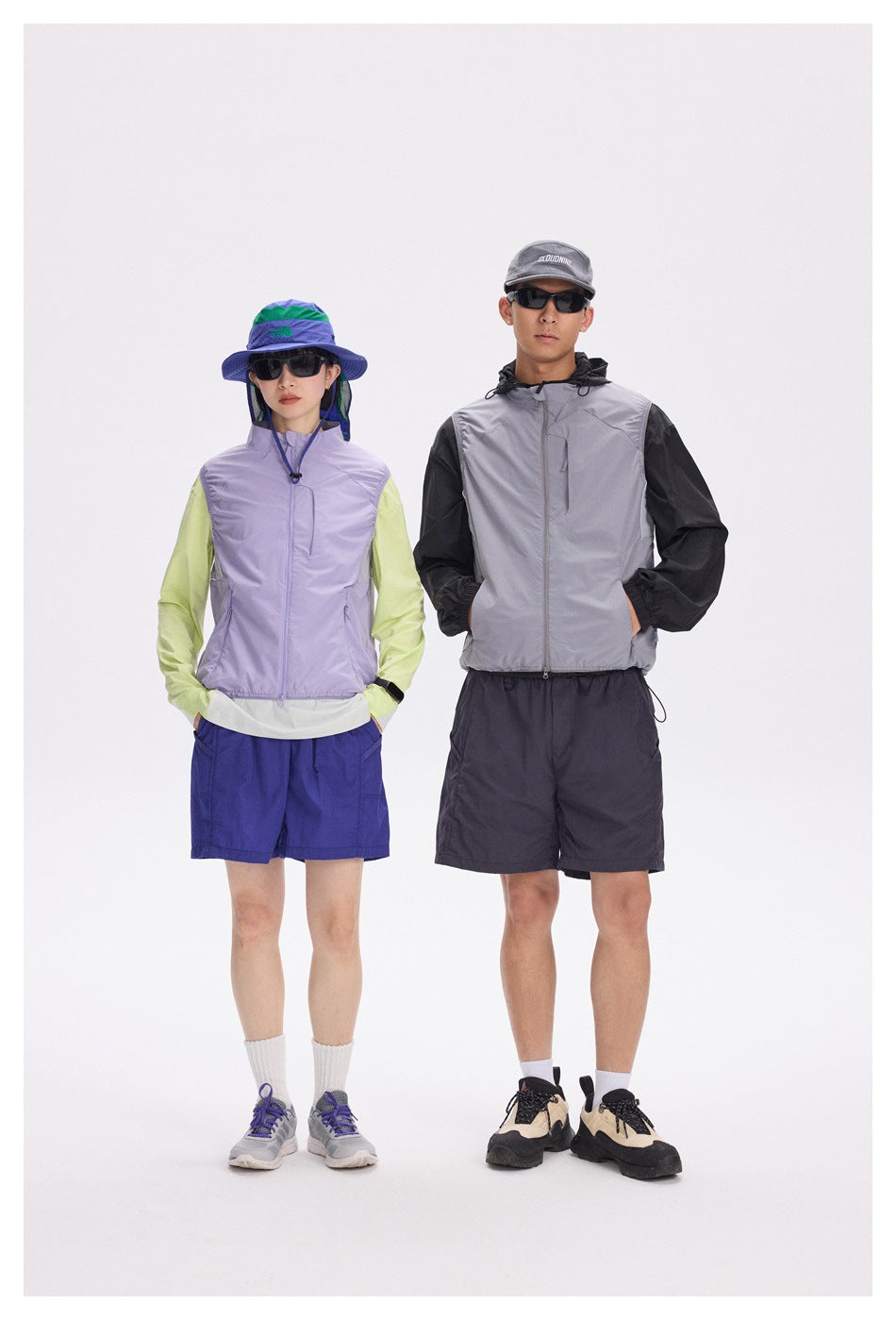 Two models wearing outdoor outfits with zip vests: lavender and lime on the left, gray and black on the right.