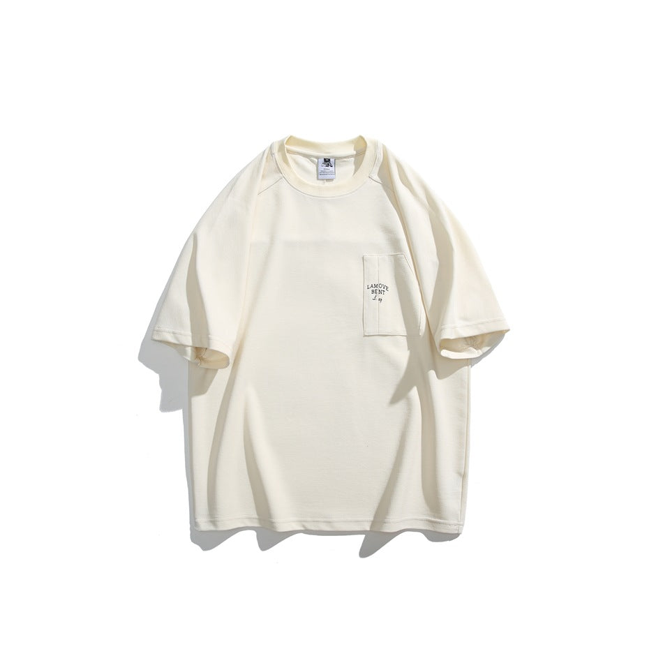 Off-white short-sleeve crew-neck T-shirt flat lay with chest patch pocket and small embroidered text