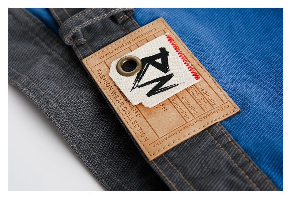 Close-up of a tan garment label with a black ZN mark attached to blue and charcoal panels.