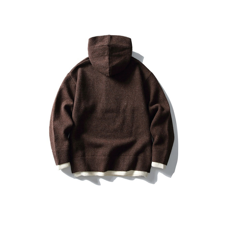 Back view of a dark brown hooded knit pullover with ribbed cuffs and hem and cream trim peeking out.