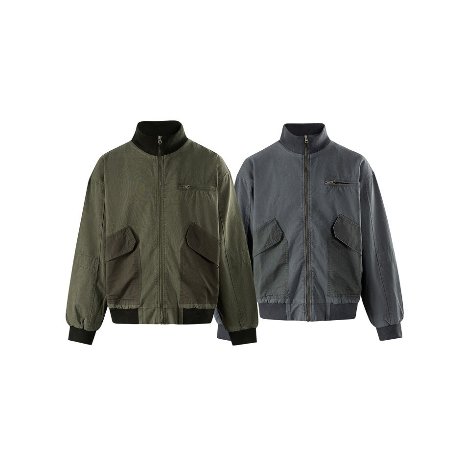 Front view of two zip-front jackets with stand collars, chest and flap pockets, in olive and charcoal gray.