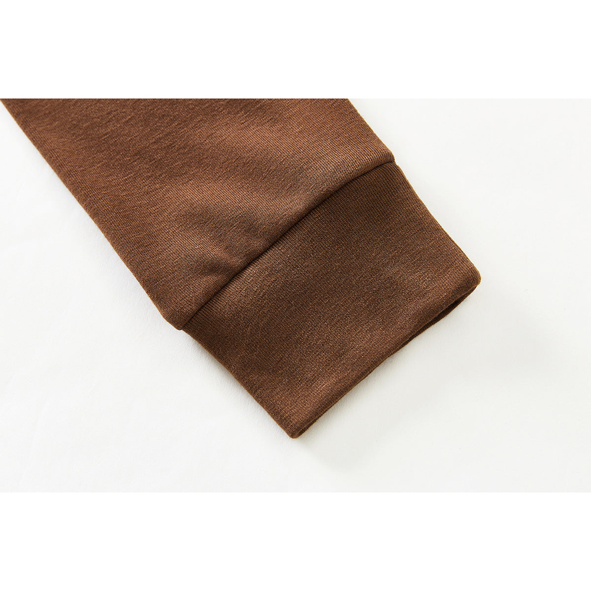 Close-up of the brown heathered long-sleeve top's wide folded cuff.