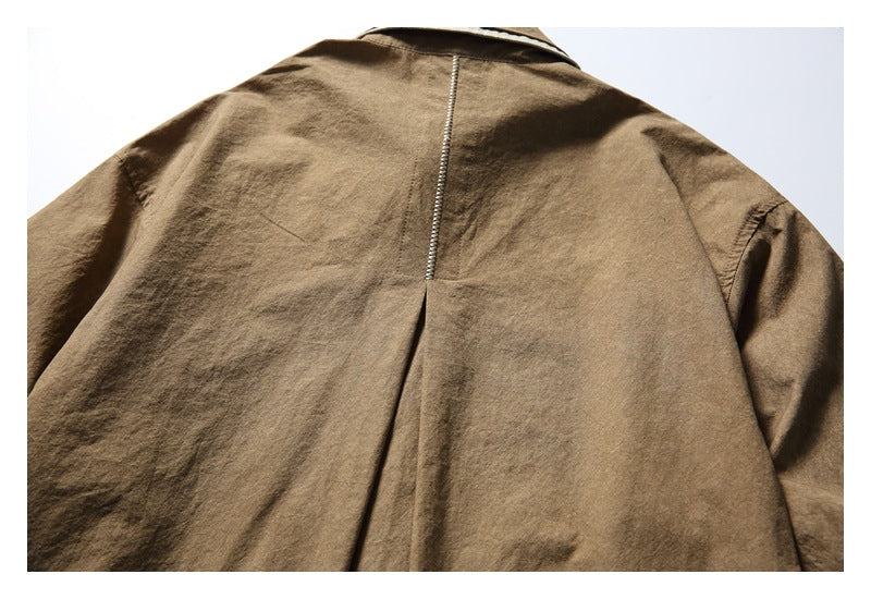 Back view of a brown long-sleeved shirt with a center seam and a pleat below the collar.