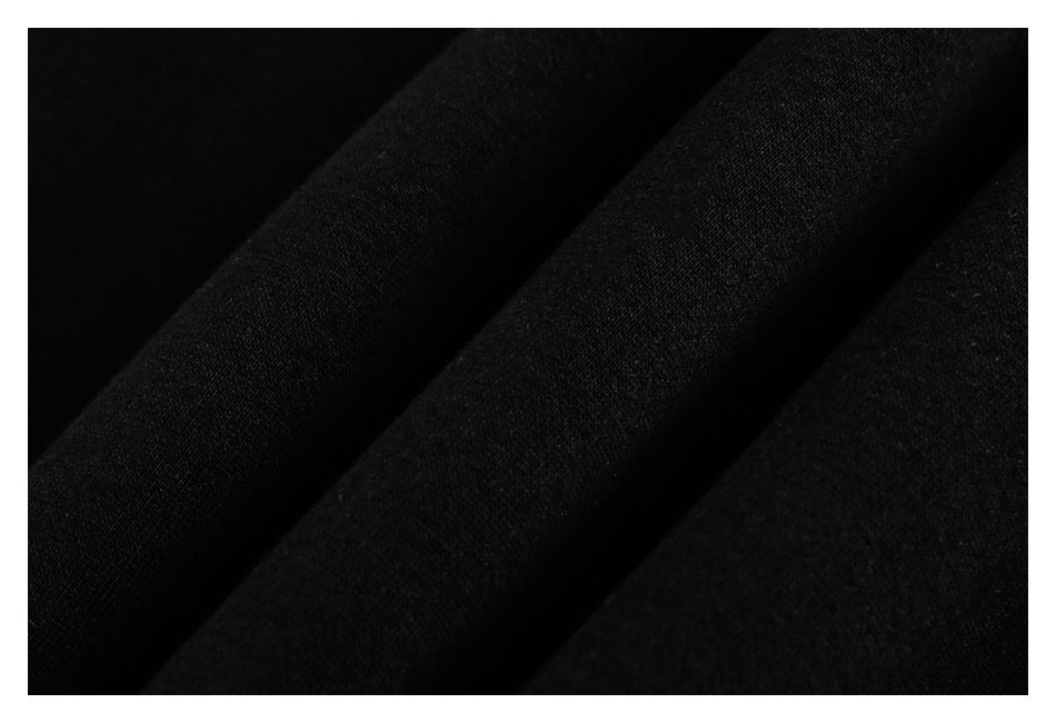 Close-up of black garment fabric arranged in soft folds.