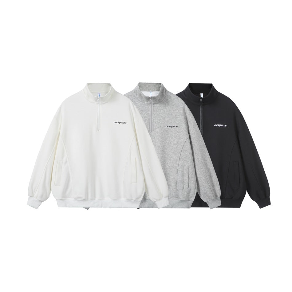 Three quarter-zip pullovers shown from the front in white, heather gray, and black.