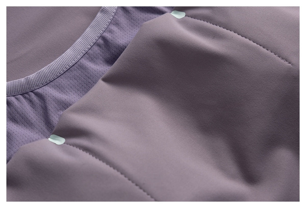 Close-up of lavender athletic top fabric, mesh panel, seams, and small pale mint details.