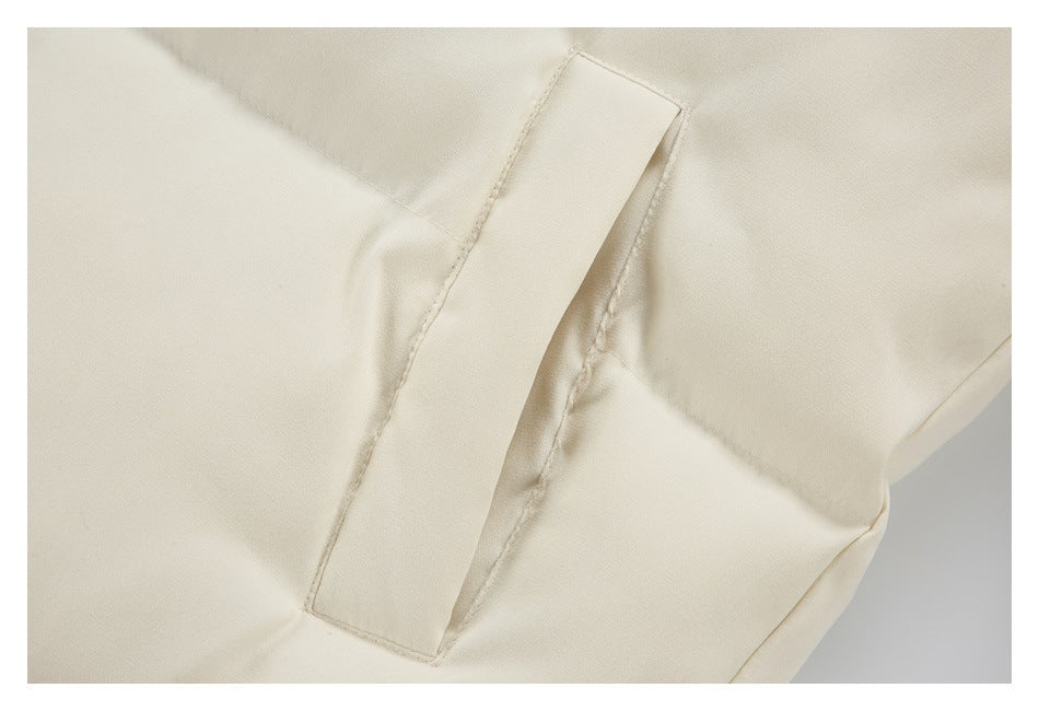 Close-up of a long, narrow cream flap and its stitched edges on the jacket.