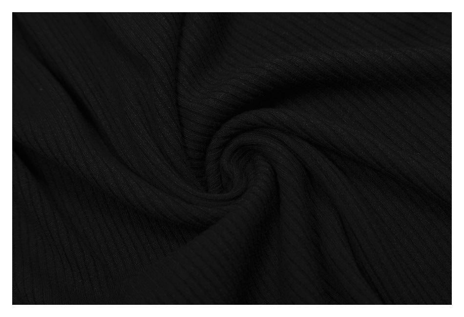 Close-up of black ribbed fabric gathered into a soft twist.