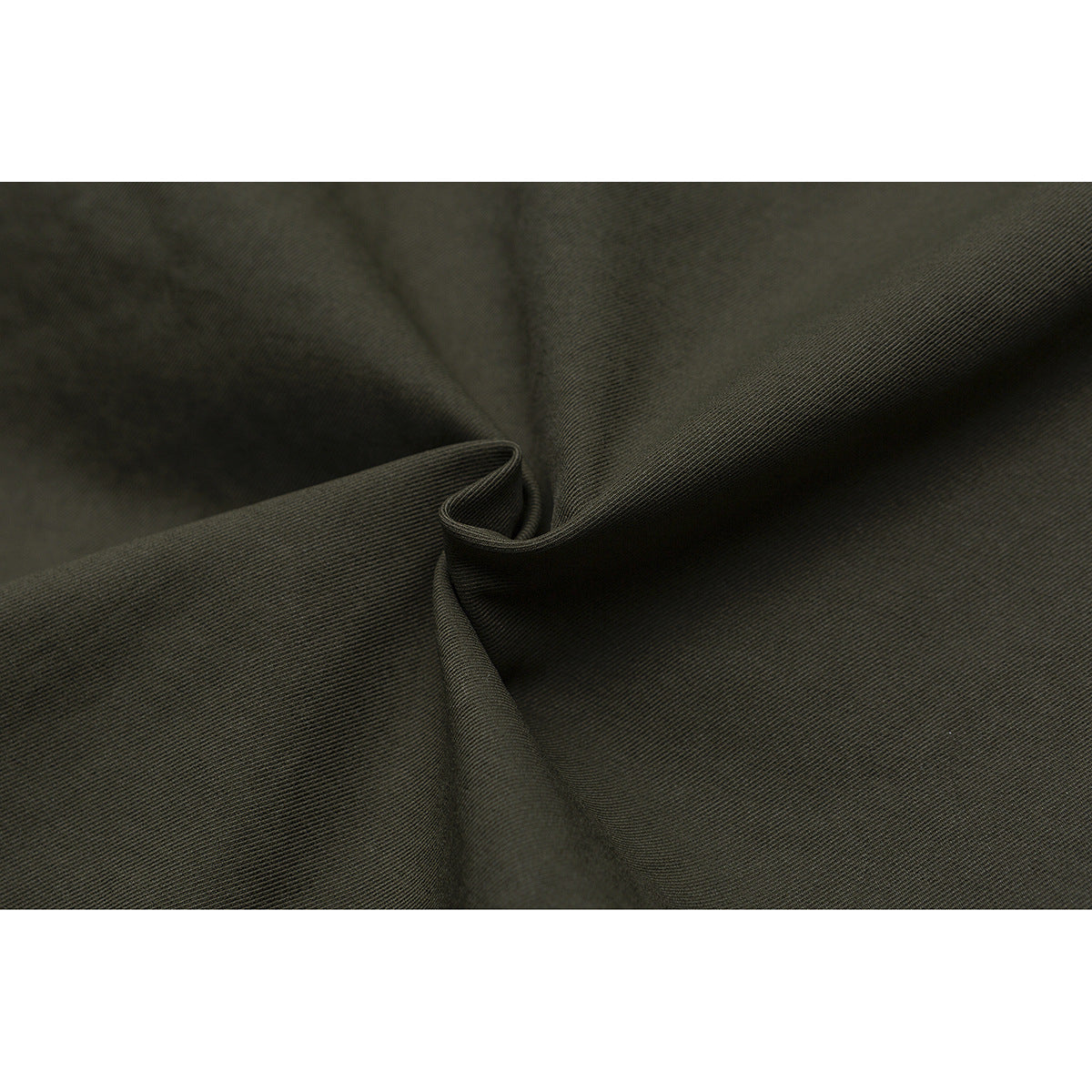 Macro view of olive fabric folded to show its fine diagonal weave.